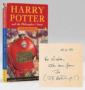 A first edition Harry Potter with book inscription.